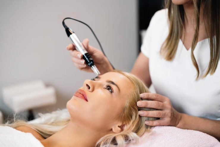 Close up shot of cosmetologist making mesotherapy injection with dermapen on face for effective skin rejuvenation. Modern cosmetology spa treatment.